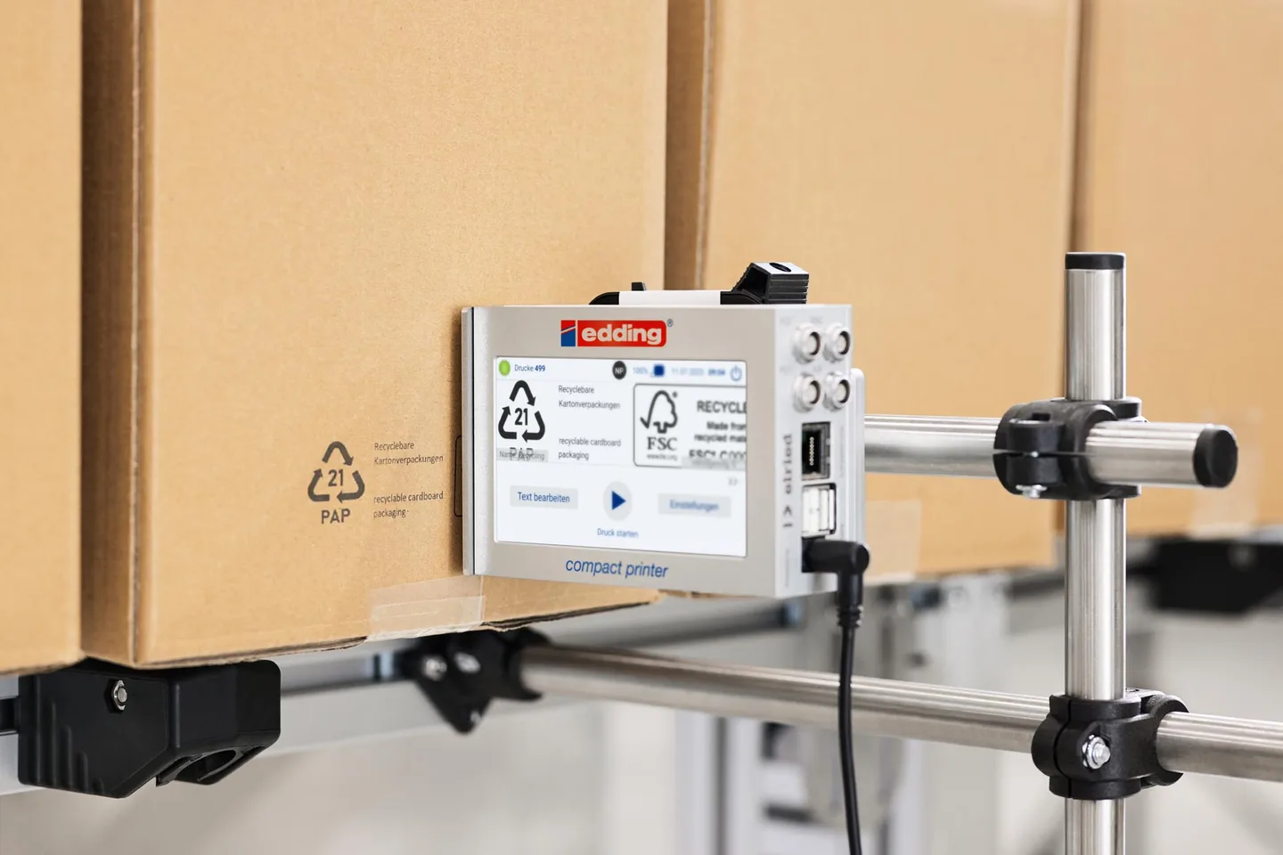 edding in-line compact printer prints on carton recycling logo.